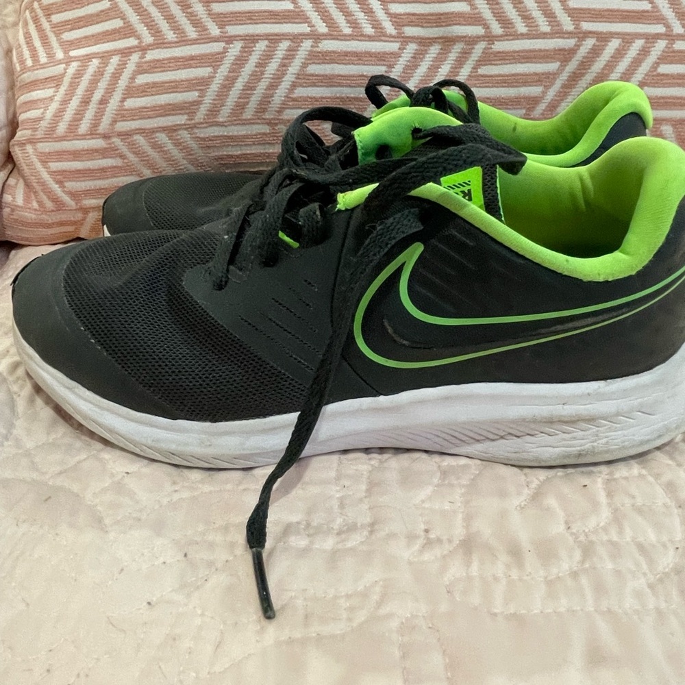 Black and green size 6 big boys Nike shoes.